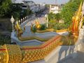 Golden serpents line the steps to the temple