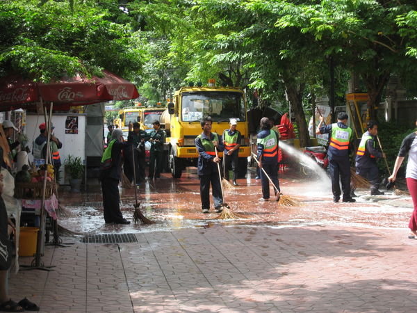 An army of cleaners washing down the street
