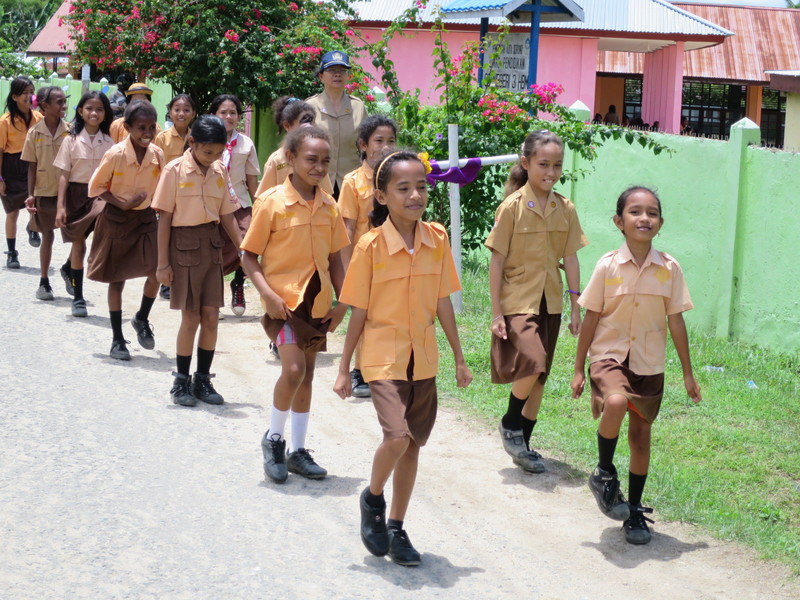 School children  marching in time to the teacher's chants