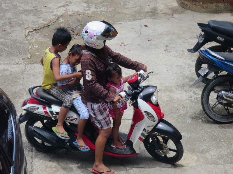 One woman , three children all on one bike