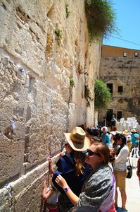 Mikaela placing her prayer in the Wailing Wall