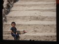 Little boy looking forlorn on the banks of the Mekong