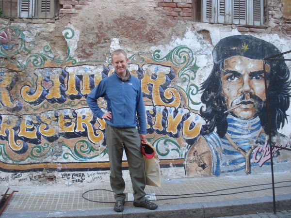 Posing with a wall painting of a very camp Che Guevara in San Telmo