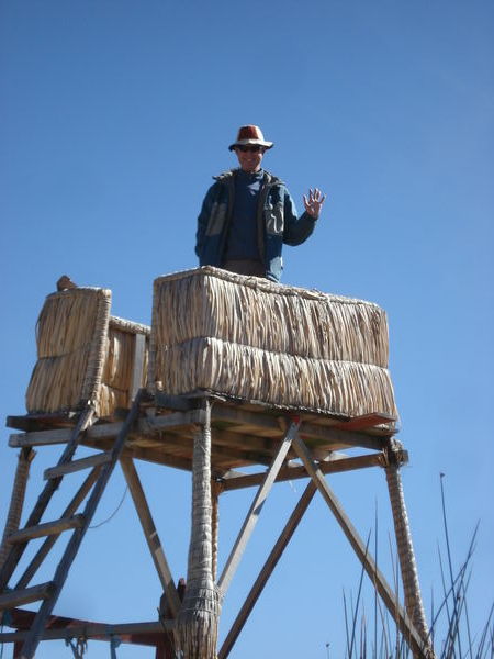 I wave from a precarious look out post on our floating islands tour - Lake Titicaca