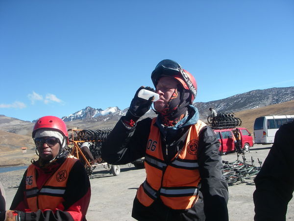 Gulping down some Bolivian grog for good luck at the start of the Worlds Most Dangerous Road