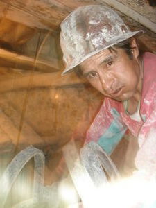A miner chews on a mouthful of coca leaves in the Cerro Rico mine