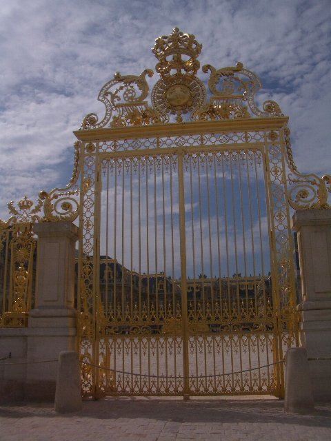 Golden gate entrance to the Palace of Versailles