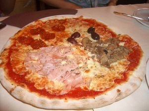 Olives, pepperoni, ham and mushroom pizza