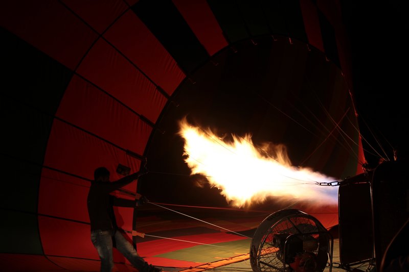 The air inside balloon being made warm with fire