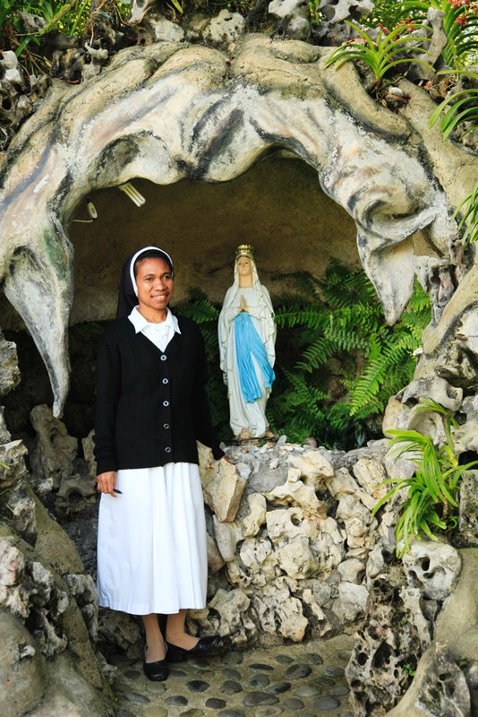 Nun at small shrine