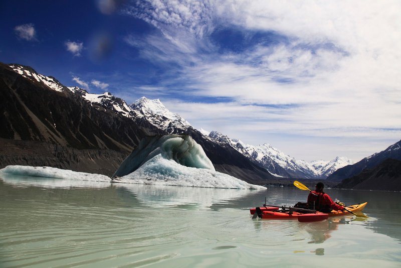 Kayaking past an iceberg