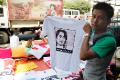 Vendor poses with NLD-Aung San Suu Kyi T-shirt