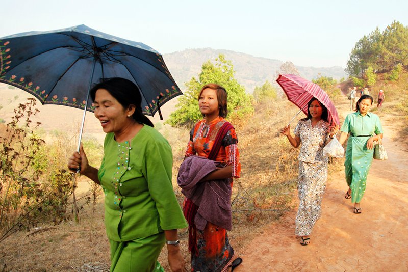Women walk the miles between the villages for a local event