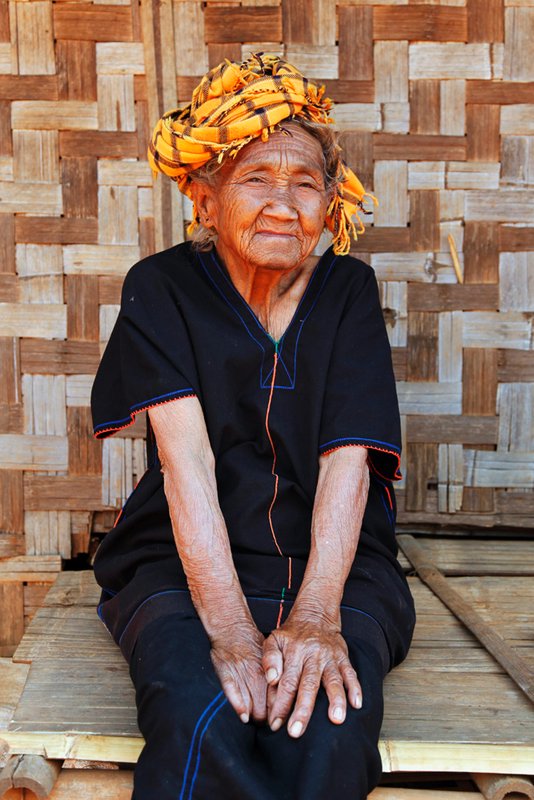 Old woman wearing tradtional outfit.