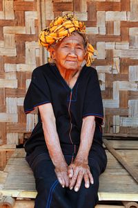 Old woman wearing tradtional outfit.