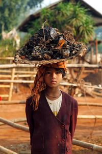 Girl carrying a load (of dung and rubbish?!)