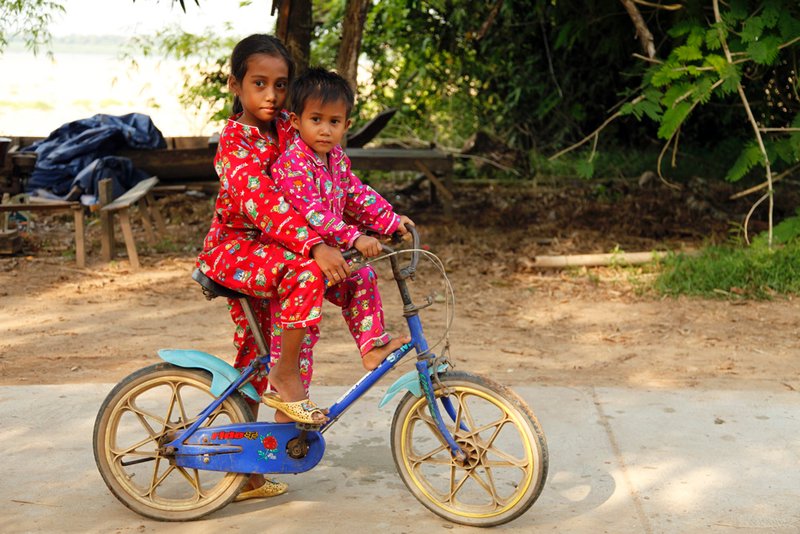 Children in pyjamas on bikes