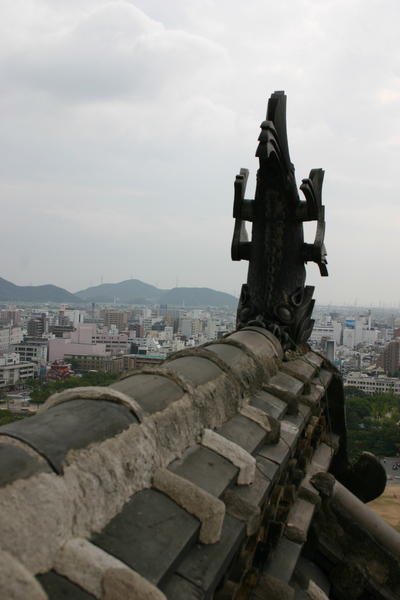 A statue seen from the top floor of Himeji Castle