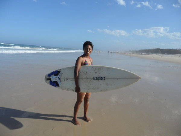 Chloe with a surfboard.