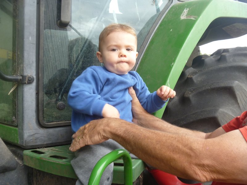 Noah sitting on the tractor step