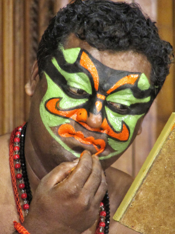 Applying makeup before a Kathakali