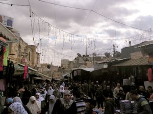 People walking toward Damascus Gate after Friday prayer