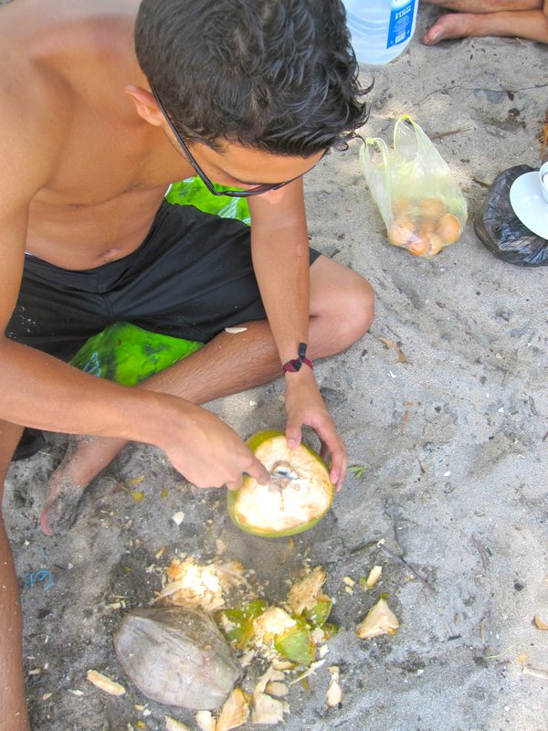 Juan Ma opening up the coconut