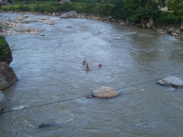 kids swimming in river at homestay