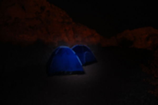 Tents in flashlight glow