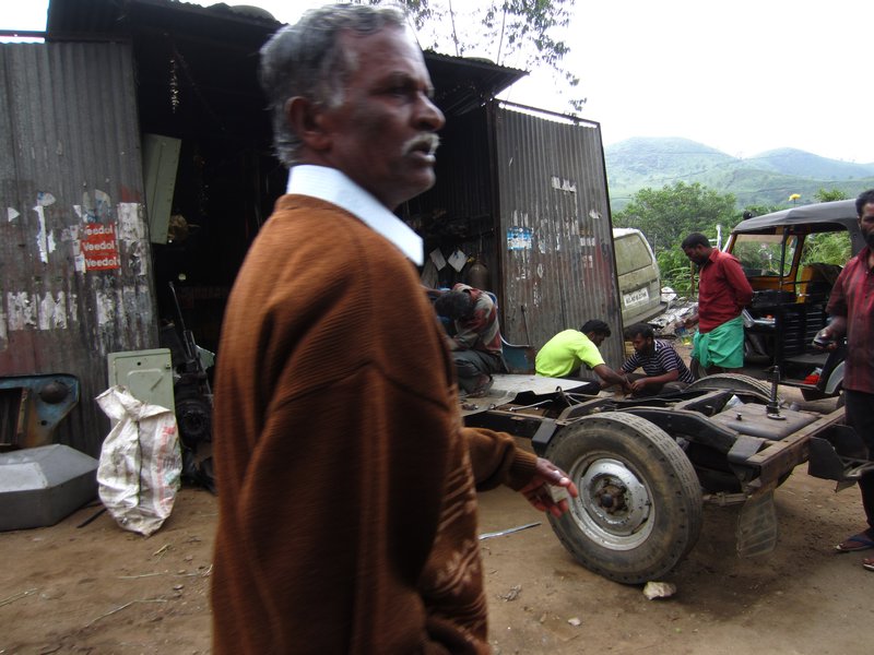 Disgruntled man and rickshaw repair