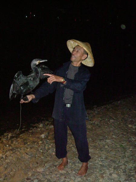 Fisherman with one of his cormorants