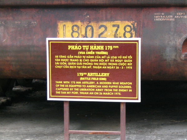 A sign next to a tank