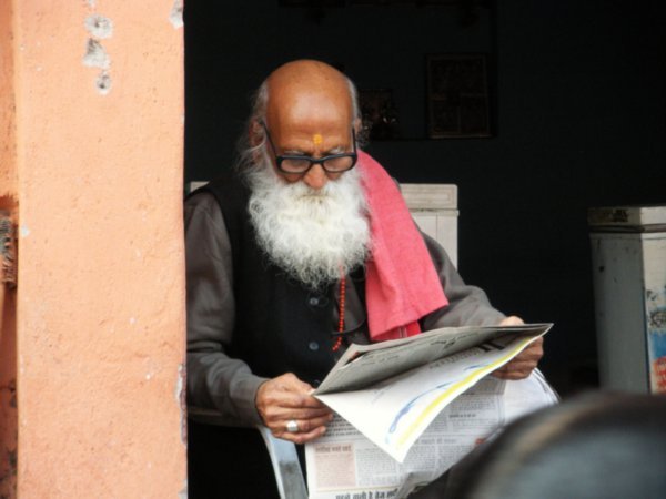 man relaxing reading the newspaper