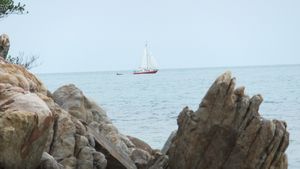 Sailing boat through the rocks