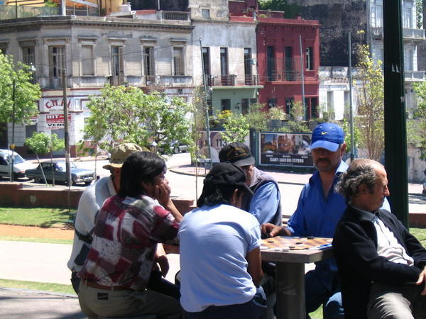 Old men playing draughts in San Telmo park on Sunday