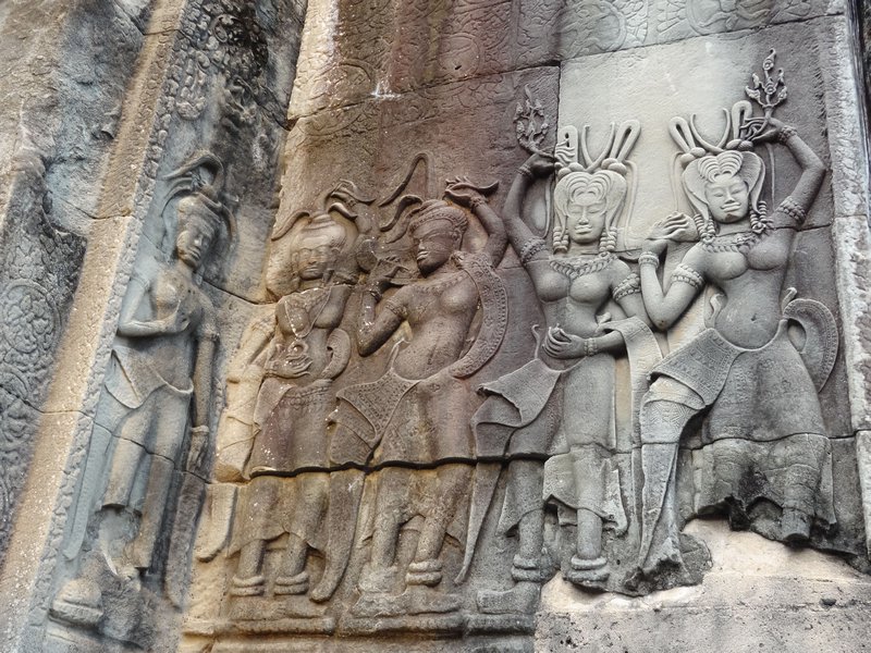 Apsaras (exotic dancers holding lotus flowers) cover the temple 