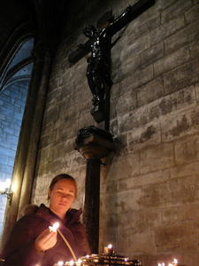 Alicia Lighting a Candle Inside Notre Dame