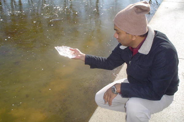 Sanjit chipping off a piece of ice at the frozen lake