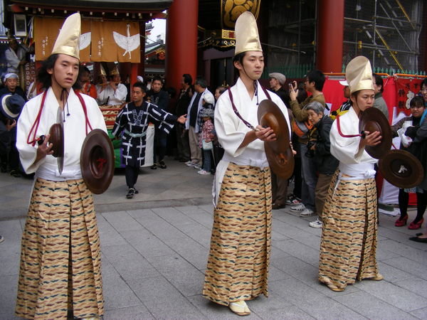 Cymbal players in parade near temple