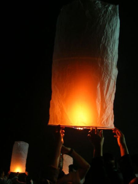 Lighting paper lanterns at the festival