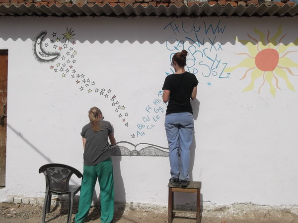 Heather and Natalie painting the slum school.