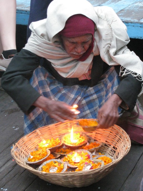 Old man handing out candles