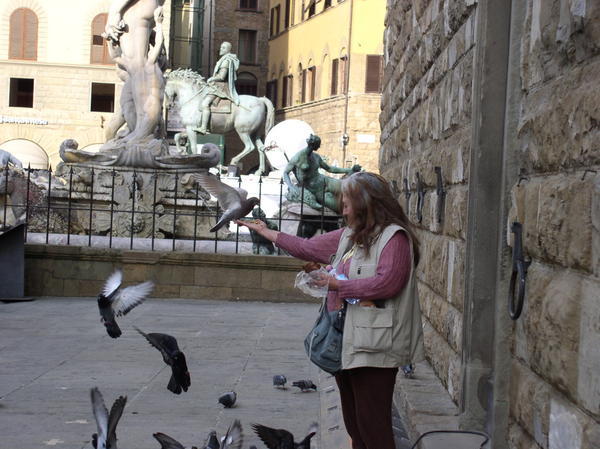 Happy lady feeding the flying rats
