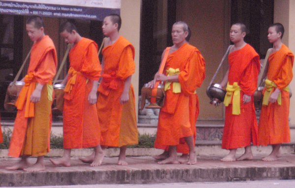 Monks queue for alms giving