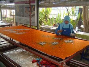 A Malay Woman Carefully Paints a Batik Design