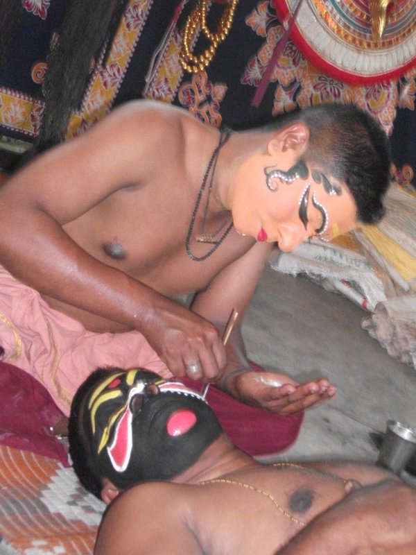 Kathakali dancers applying makeup