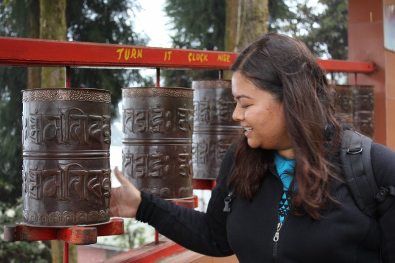 Sonia turning prayer wheel's at the Tibetan self help centre
