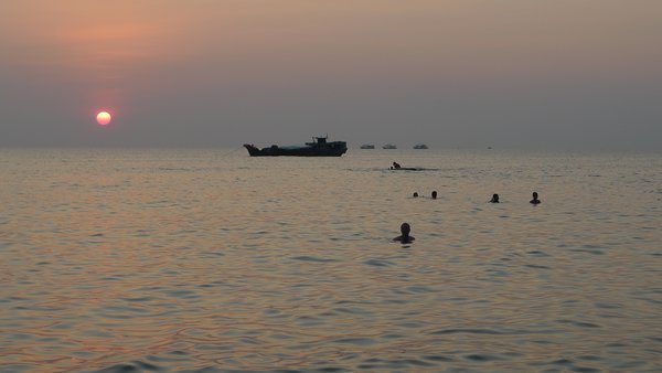 Locals enjoying an evening swim at the beach near our bungalow.