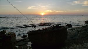 Sunset view from the patio.  The large woven bowl is actually a type of fishing boat.  Local kids love to play in the water around here.