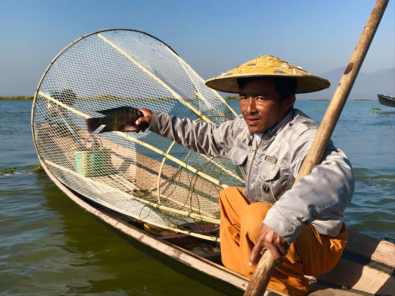 Fisherman holding fish, Inle Lake
